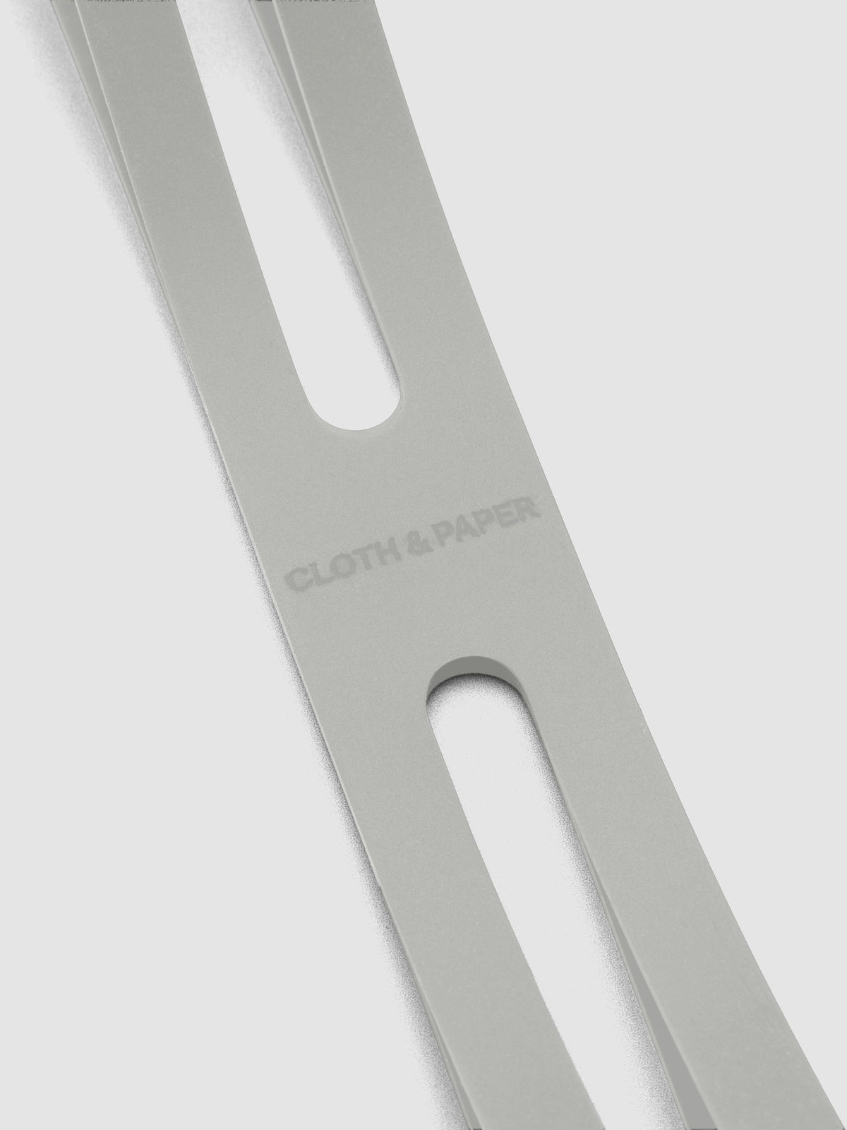 Close up of the debossed Cloth and Paper logo on the small ash planner closure band.