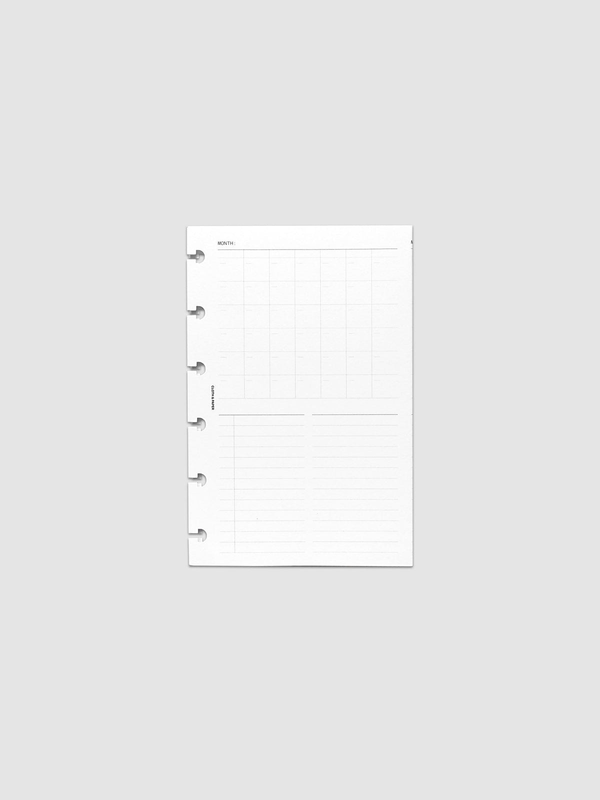 Monthly Fold Out Planner Insert Set of 2, CP Petite 6-Disc Punch, one white insert folded closed and shot flat and straight on, six disc notches cut into the left edge