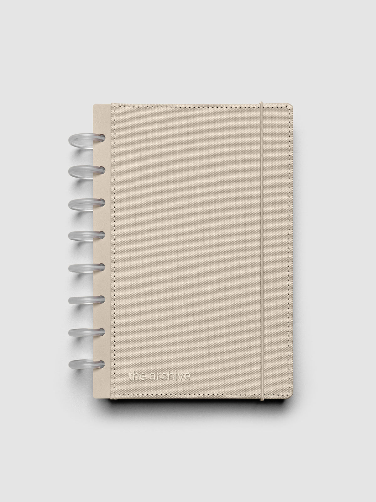 Half Letter discbound planner with a beige bookcloth cover against a grey background.
