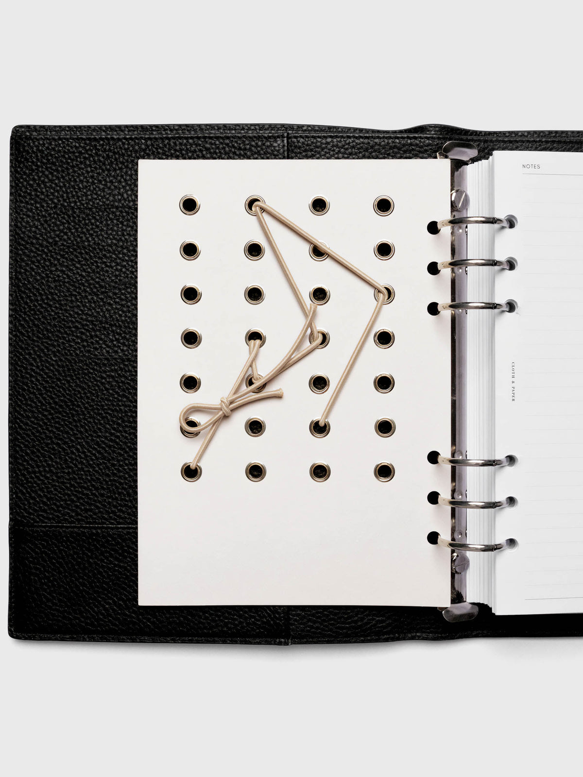 Cadence Dashboard with grommets and string on beige cardstock shown in size A5 for 6-ring planners and notebooks.
