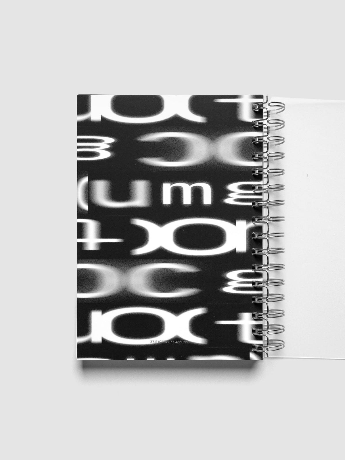 Spiral Notebook dashboard in the pattern Blurred Letters shown in size A5 inside a notebook.