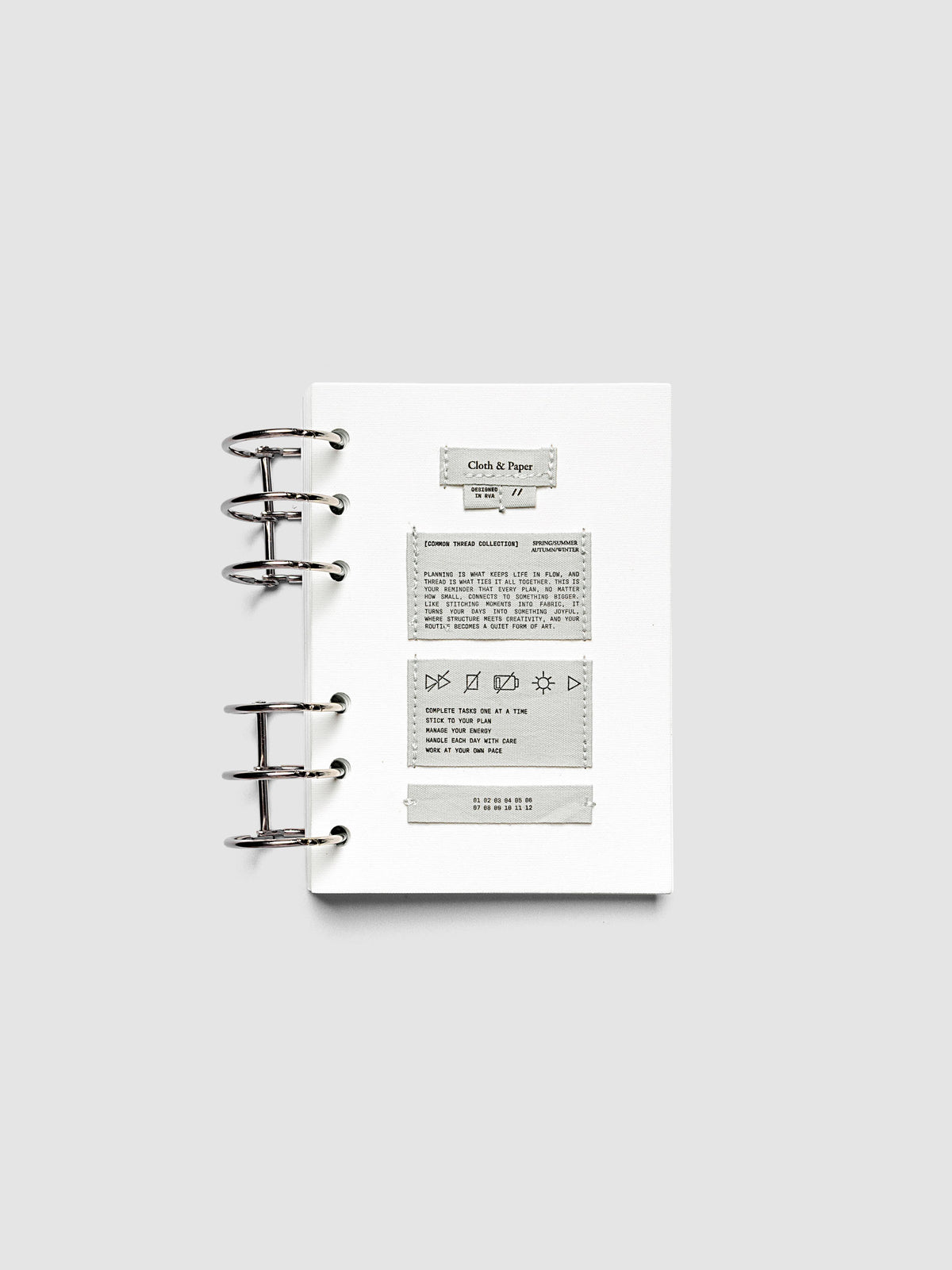 Sewn Tags Planner Dashboard pre-punched for 6-ring planners in size A6 shown ring bound.