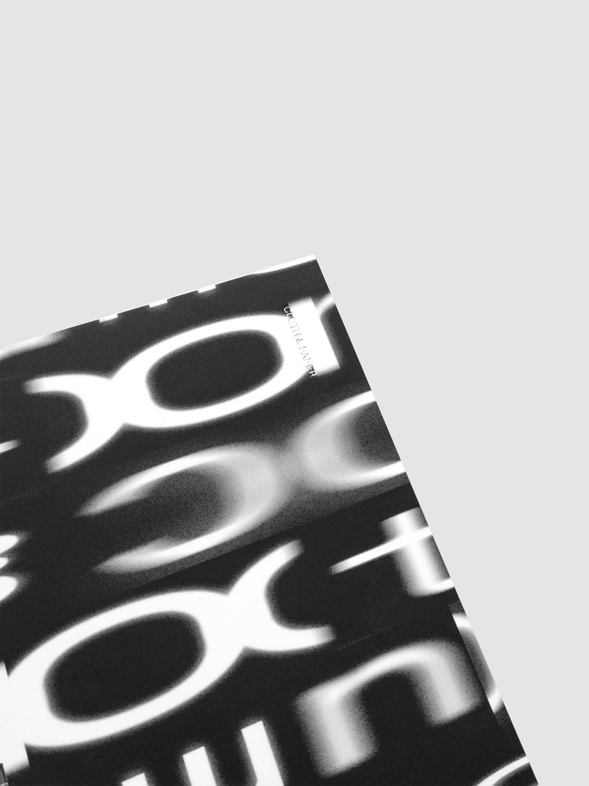 Detail view of the Spiral Notebook dashboard in the pattern Blurred Letters shown in size CP Petite against a neutral background.