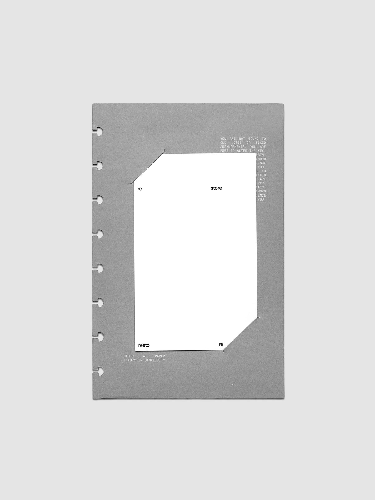 Grey cardstock planner dashboard with white plastic card inserted in slits with white printed text shown in size Half Letter for discbound planners.