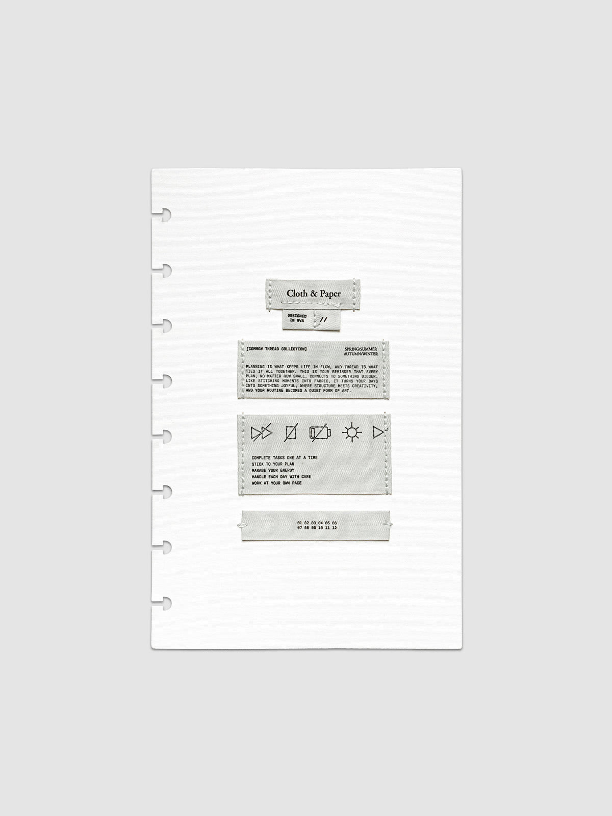 Sewn Tags Planner Dashboard shown pre-punched for discbound planners in size Half Letter.