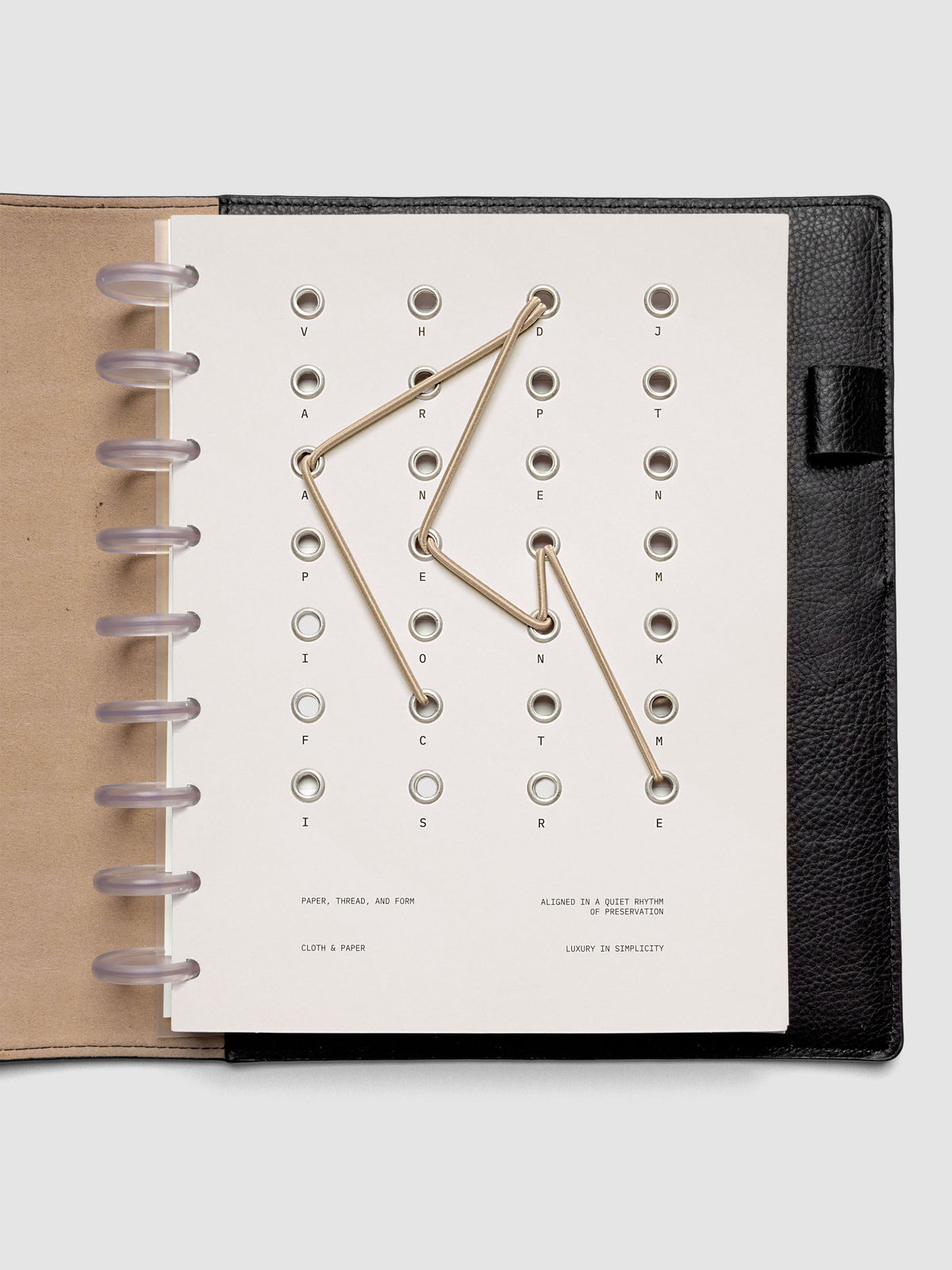 Cadence Dashboard with grommets and string on beige cardstock shown in size HP Classic for discbound planners and notebooks.
