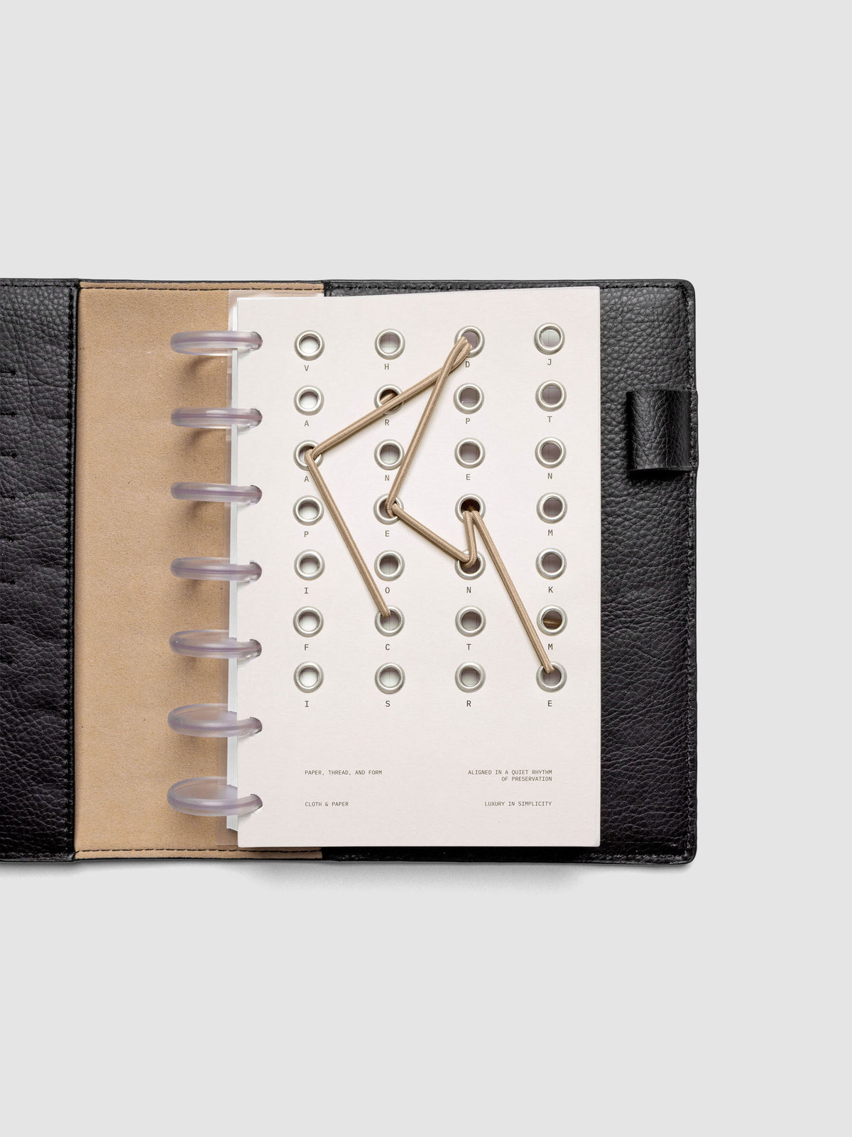 Cadence Dashboard with grommets and string on beige cardstock shown in size HP Mini for discbound planners and notebooks.