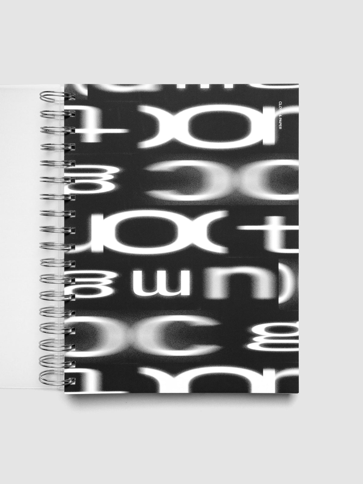 Spiral Notebook dashboard in the pattern Blurred Letters shown in size HP Classic inside a notebook.