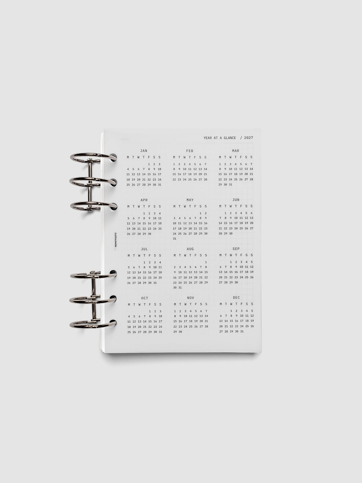 2027 Year At A Glance Dashboard Monday Start, Personal Wide 6-Ring Punch, translucent vellum year-at-a-glance calendar shown inside a planner