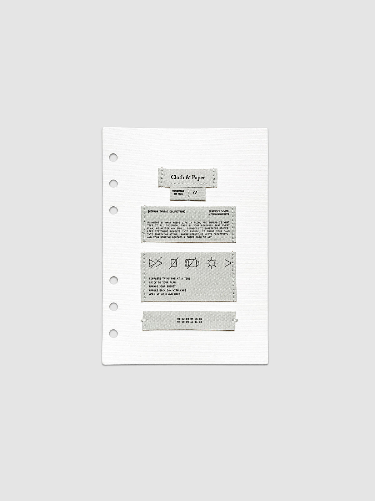 Sewn Tags Planner Dashboard shown pre-punched for 6-ring planners in size Personal Wide.