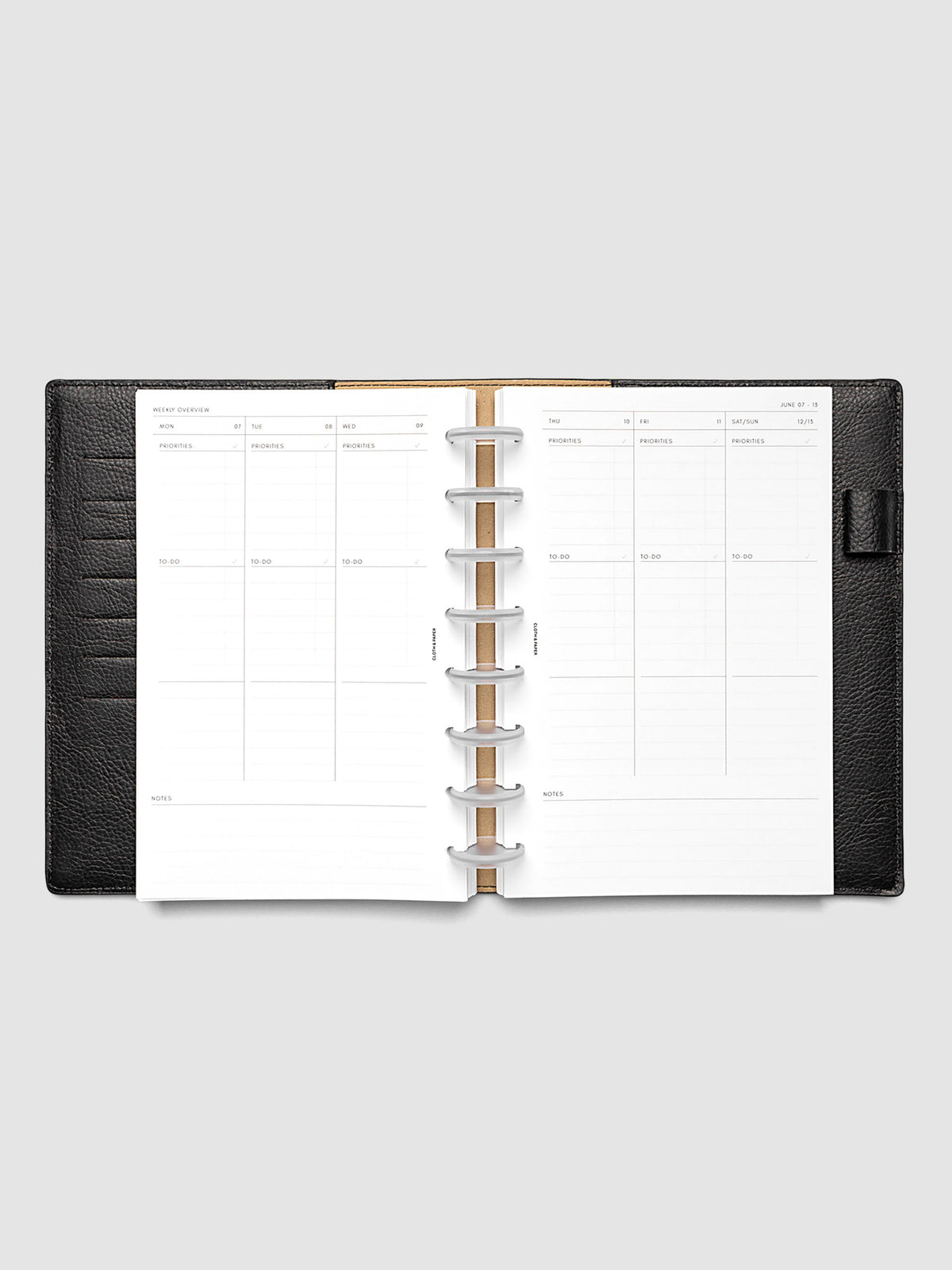 Both pages inside planner: 2027 Dated Weekly Task Planner Inserts, Monday Start, Half Letter 8-Disc Punch, full week-on-two-pages spread showing blank vertical columns for each day with labeled priorities, to-do, and notes sections, Saturday and Sunday combined, and weekly notes section along the bottom, shown inside a planner