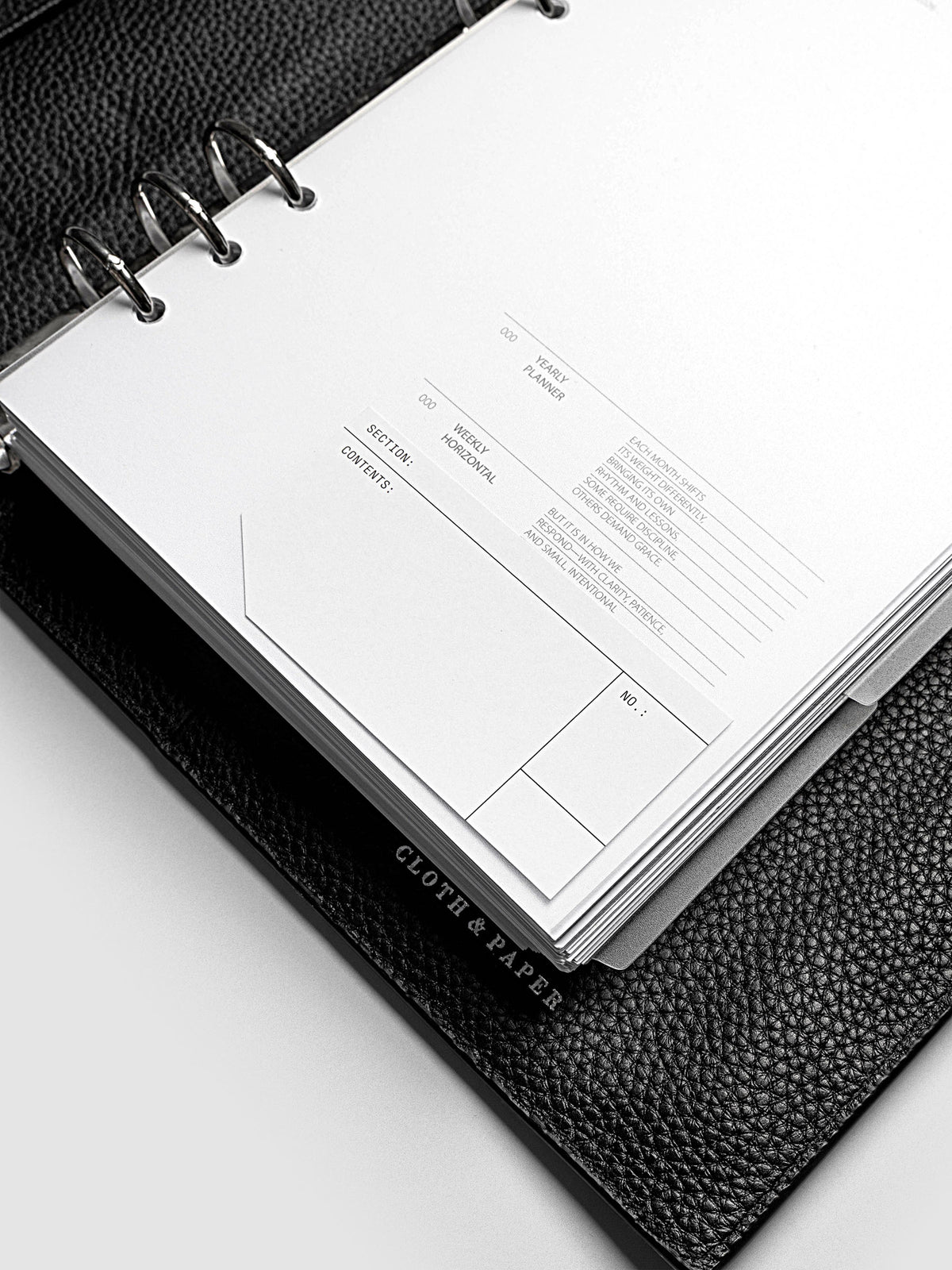 Clear side tab dividers sized for A5 planners shown in use with a blank label with headers section, content, and no.