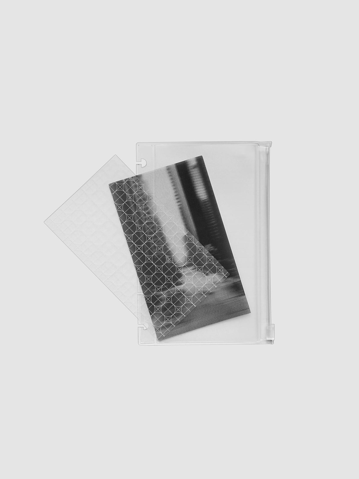 One transparent graph overlay, one black and clear abstract photo overlay, and one clear pre-punched zippered pouch for planners. Shown in size CP Petite.