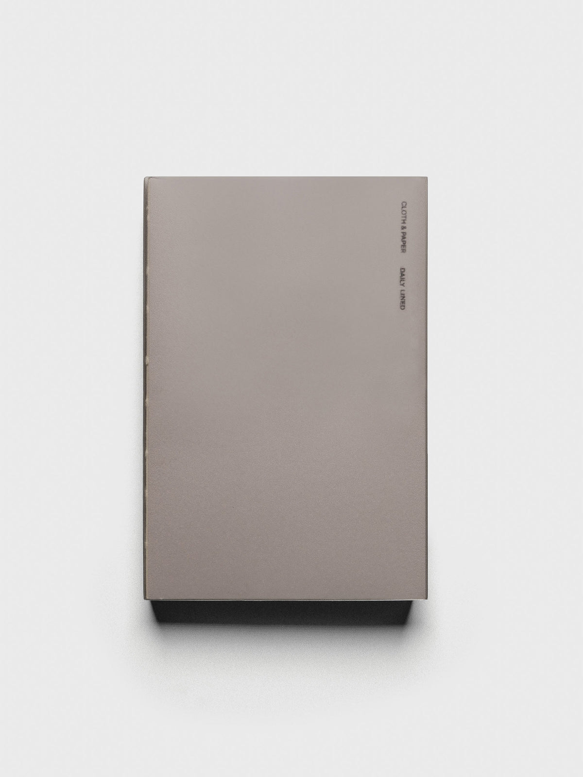Perfect Bound Notebook | CP Petite | Daily Lined | Verona shown closed, laying flat, on a neutral background.