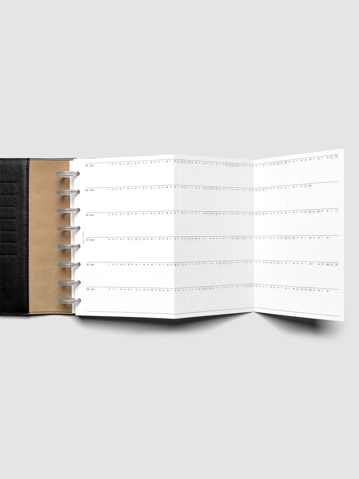 2026 Yearly Fold Out Planner Insert in size Half Letter shown un-folded in a black leather folio cover.