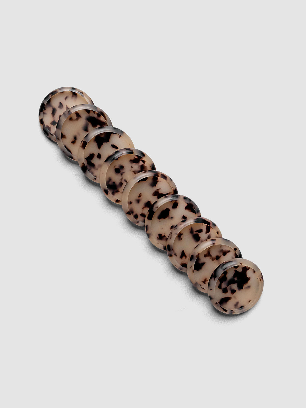 Plastic Planner Discs in the pattern Desert Tortoiseshell shown in 1" Inch sizing.