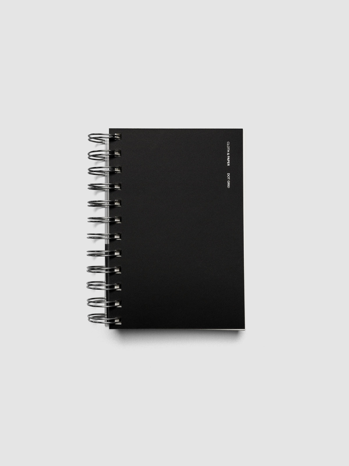 Spiral Notebook in size CP Petite and color Avant Garde with Dot Grid interior pages shown closed displaying the soft touch dashboard.