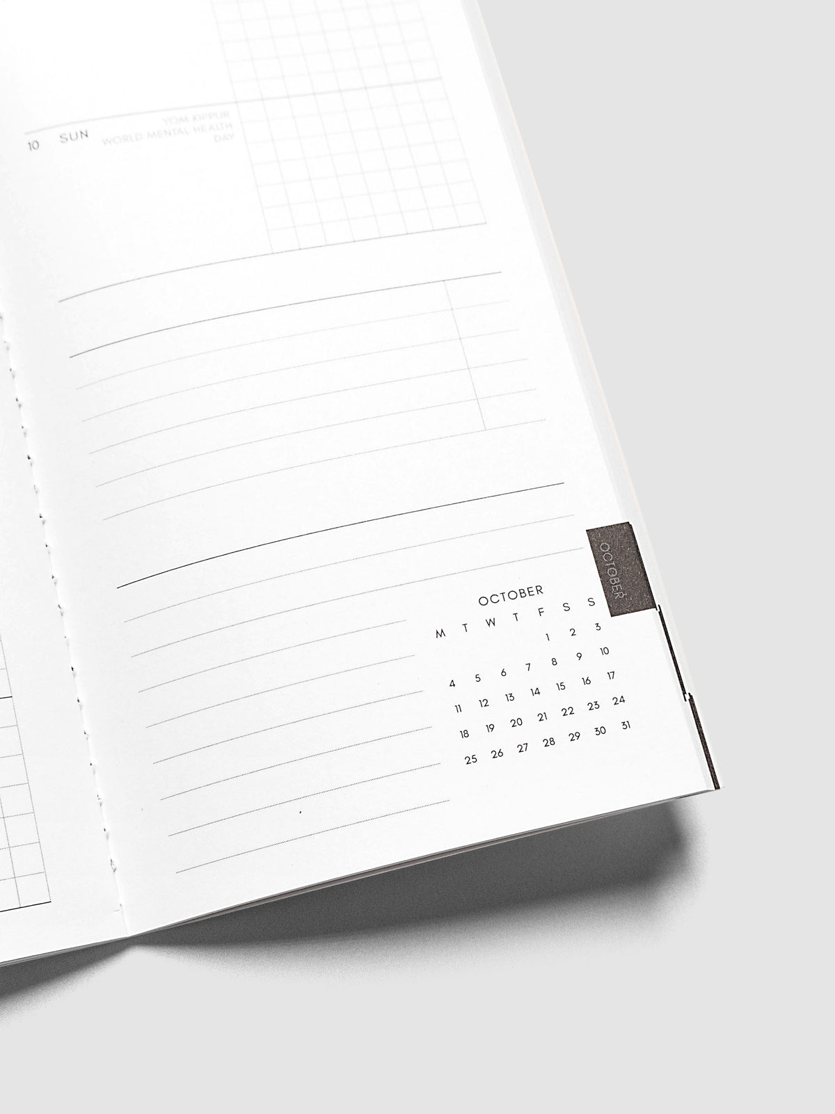 Close-up of the bottom of the right page of the Jul–Dec 2027 Dated Travel Notebook, showing the lined notes section and month-at-a-glance view