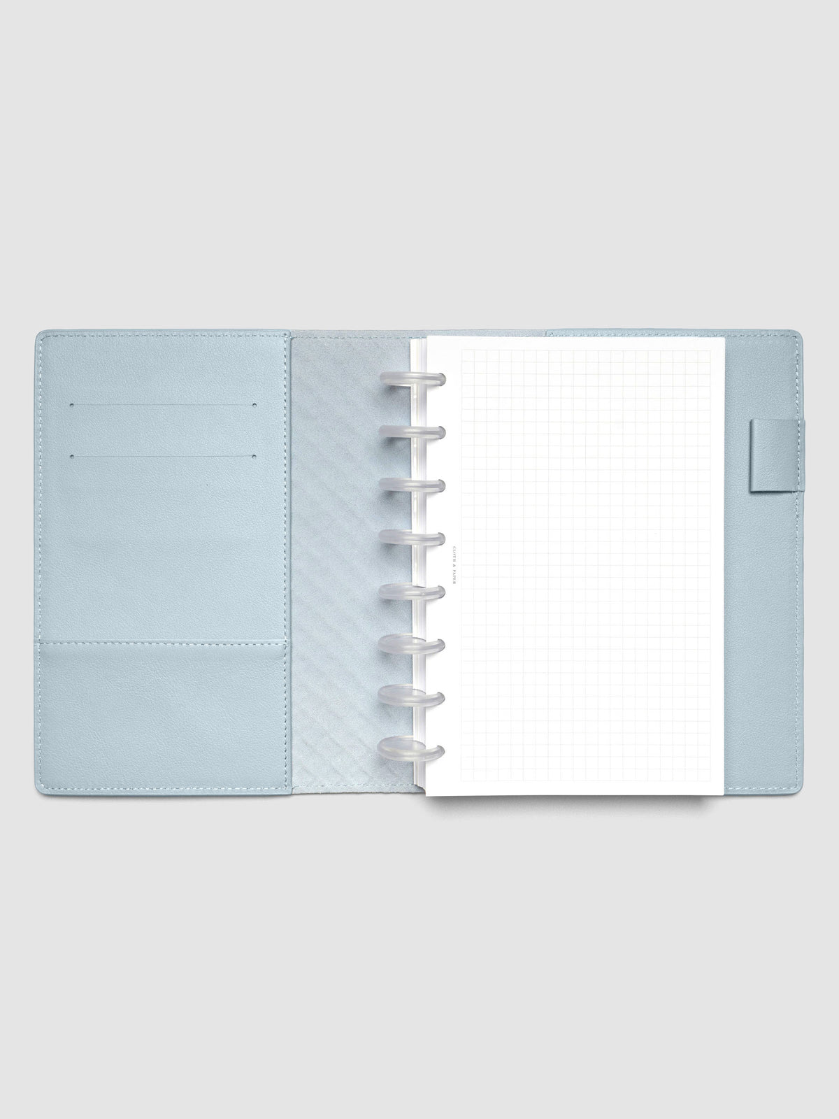 Light blue leather planner folio with an Half Letter discbound planner inside.