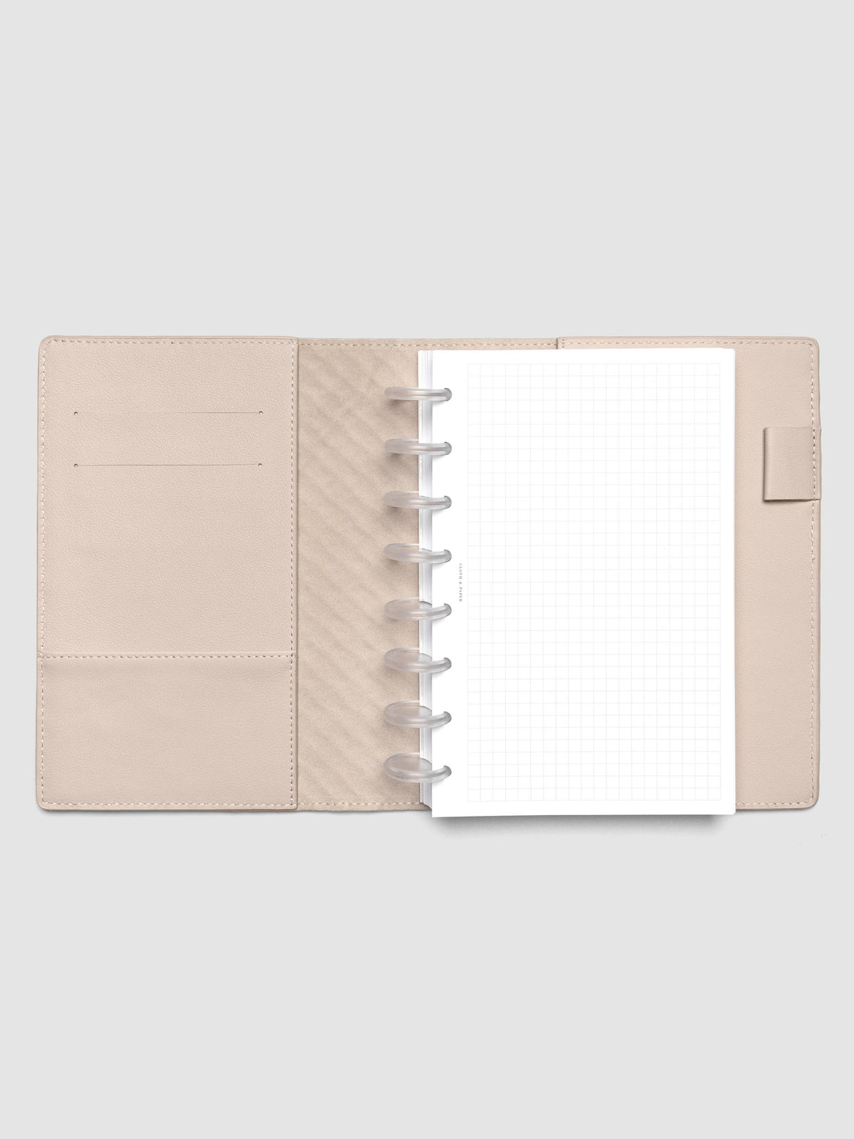 Beige leather planner folio with an Half Letter discbound planner inside.