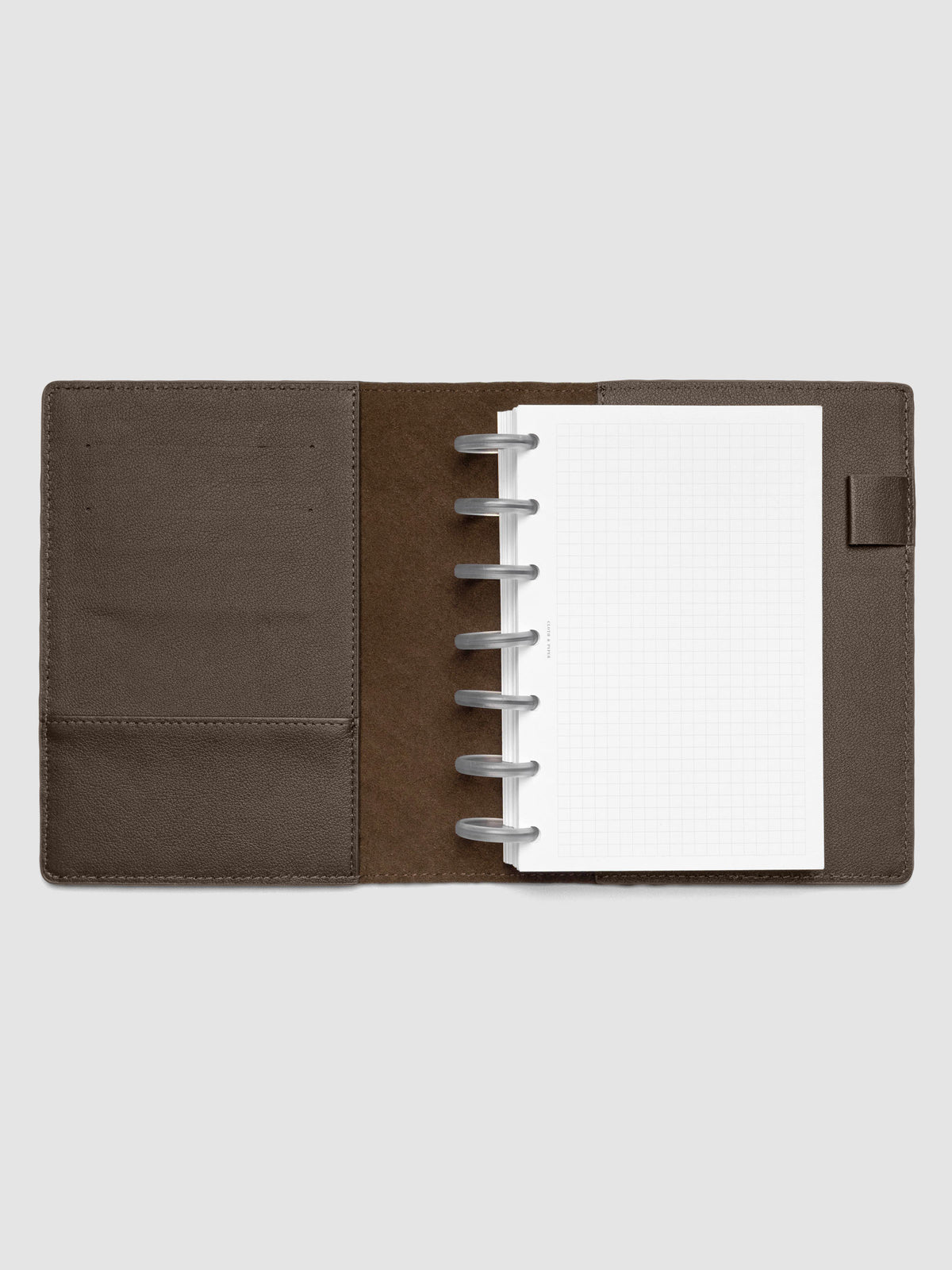 Dark brown leather planner folio with an HP Mini discbound planner inside.