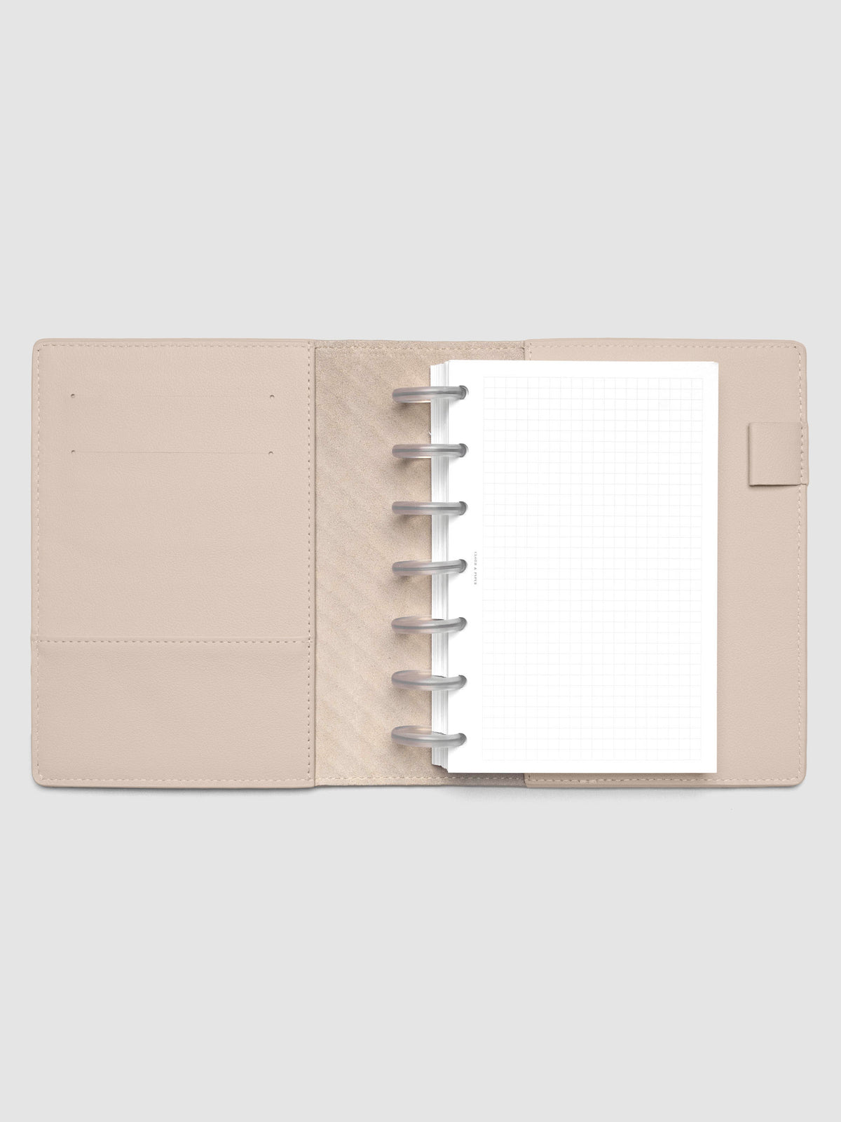 Beige leather planner folio with an HP Mini discbound planner inside.