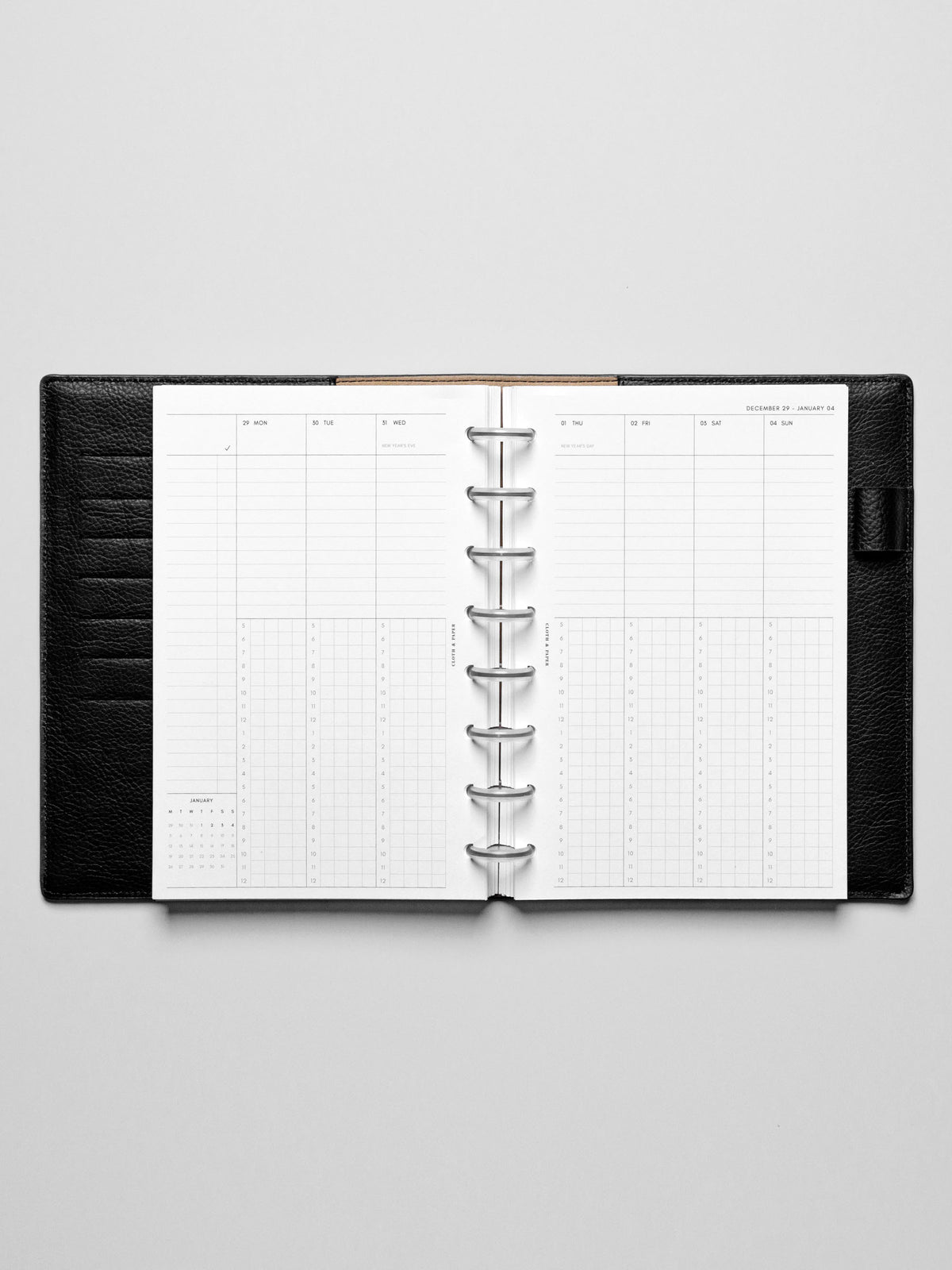Image shows the Monday Start 2026 Dated Weekly Schedule Planner Inserts in a black leather disc-bound planner.