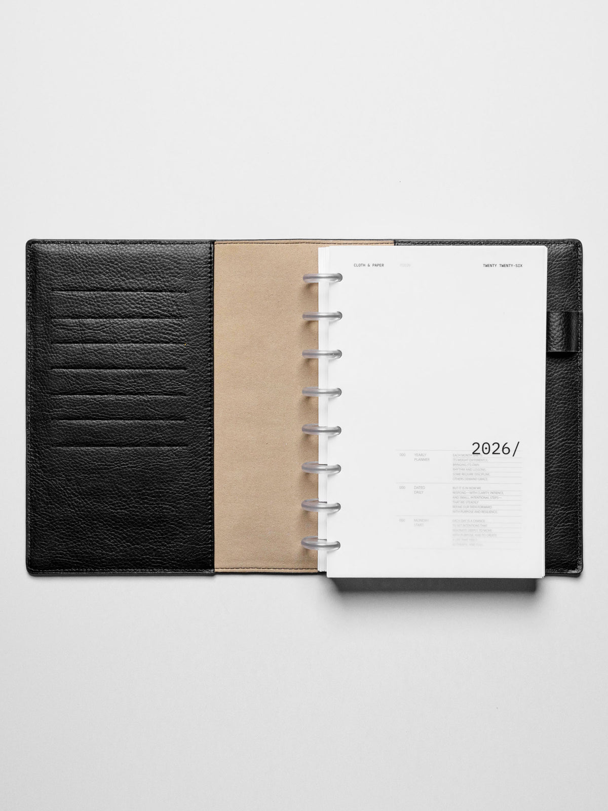 Image shows the 2026 front cover used in a black leather Half Letter disc-bound planner.