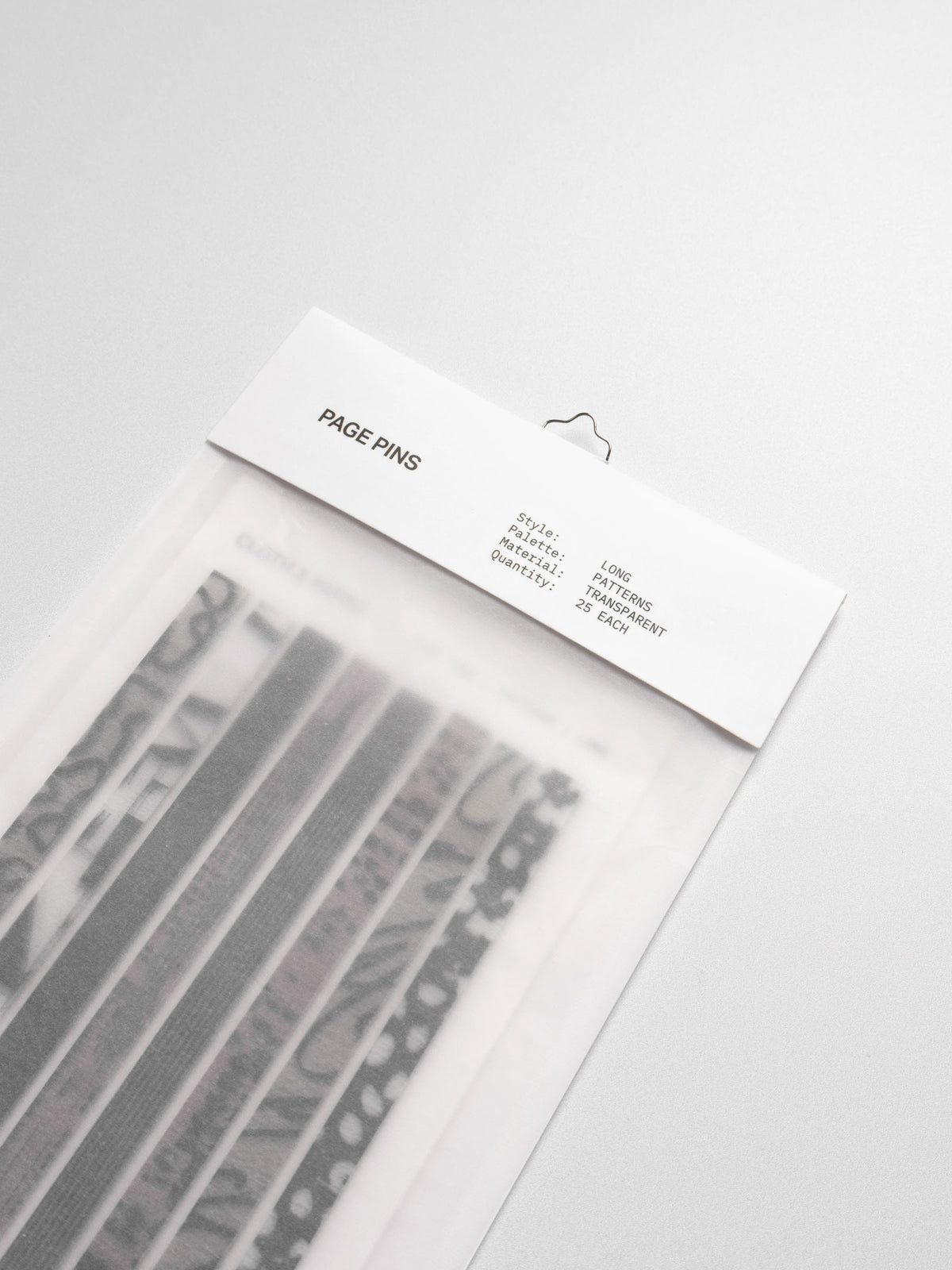 Long page pins displayed in their packaging on a neutral background.