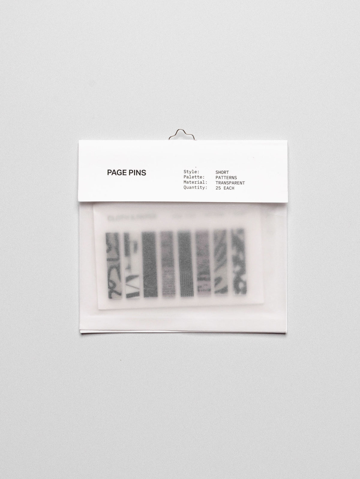 Short page pins displayed in their packaging on a neutral background.