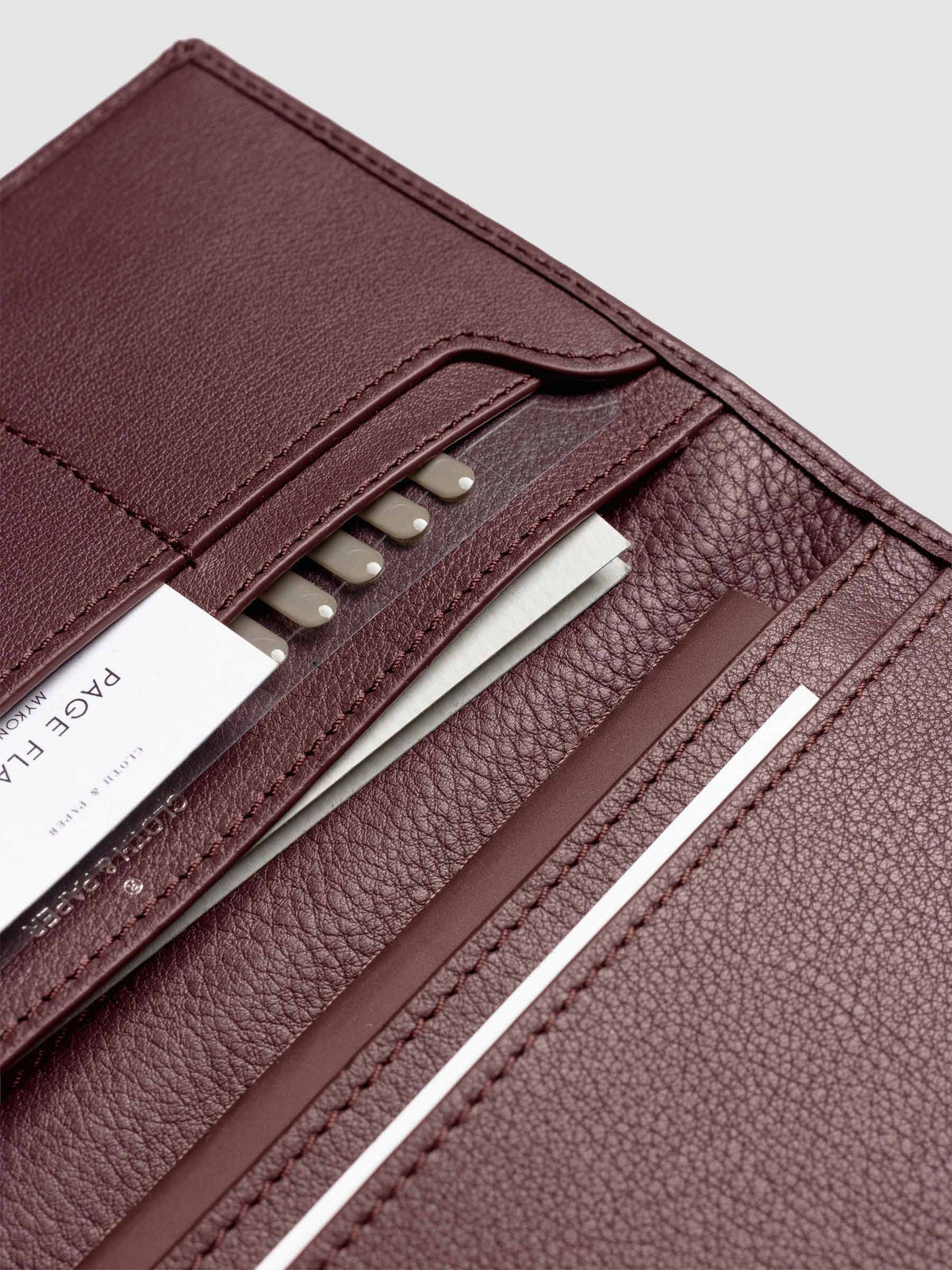 Close-up of Cloth & Paper products inside open Nomada Wallet pockets in Madrid