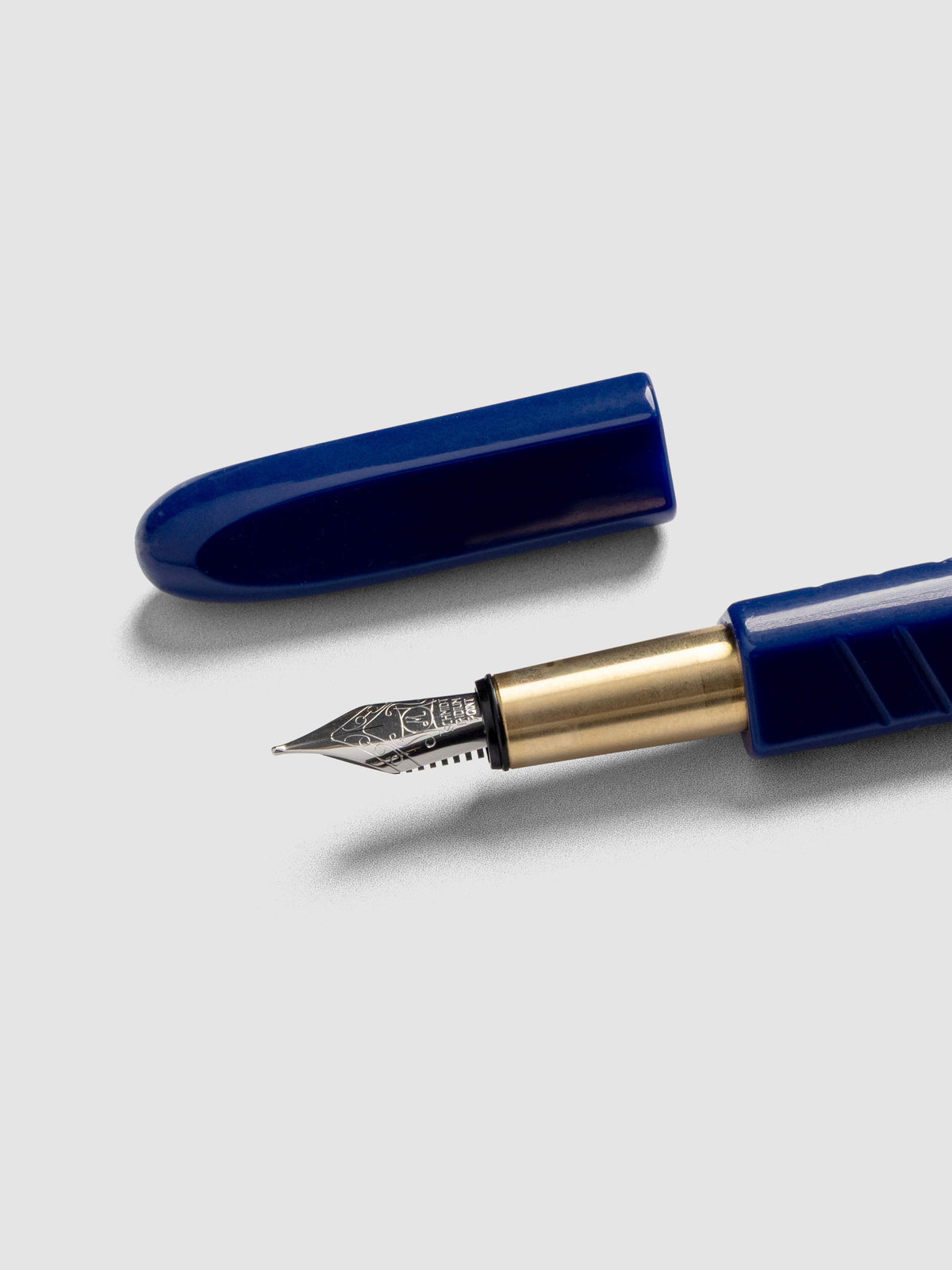 Kolo Tino Fountain Pen in the color Acrylic Albert Blue, a cobalt barrel with brass accents and a silver medium nib shown with cap off.