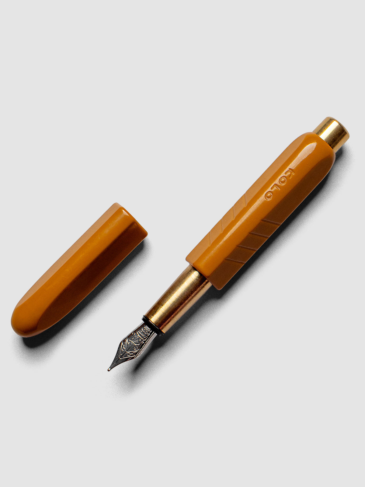 Kolo Tino Fountain Pen in the color Acrylic Sunny, a golden yellow with brass accents and a silver medium nib shown with cap off.