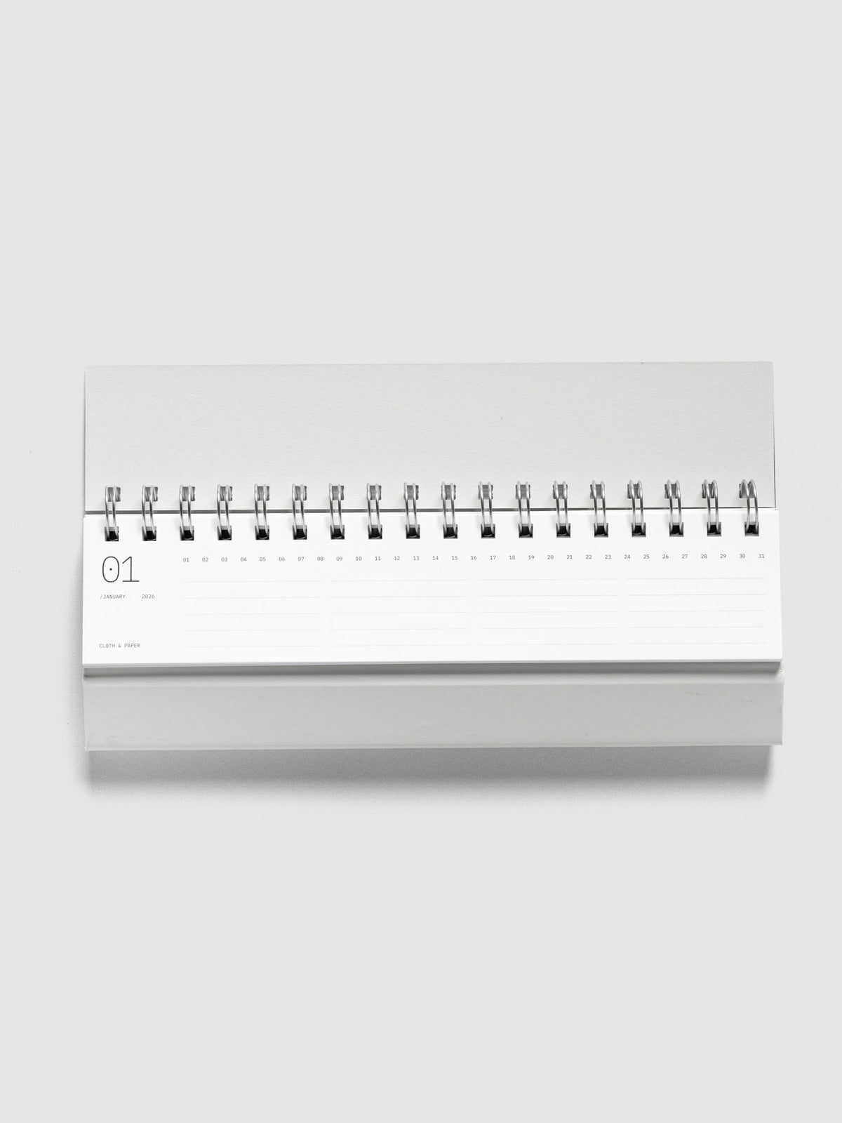 2026 Spiral Desk Calendar shown folded and flat, displaying a calendar page.