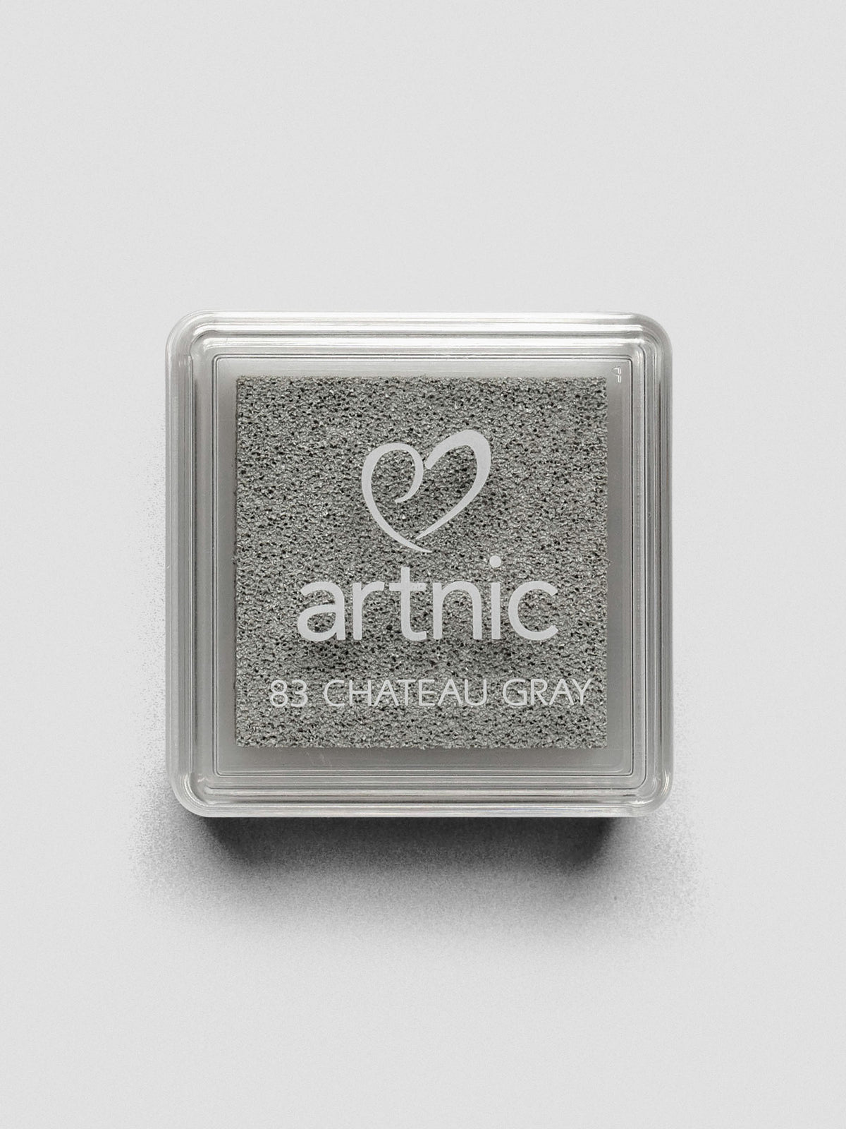 Square gray Artnic ink pad with clear lid labeled “83 Chateau Gray,” viewed from above.