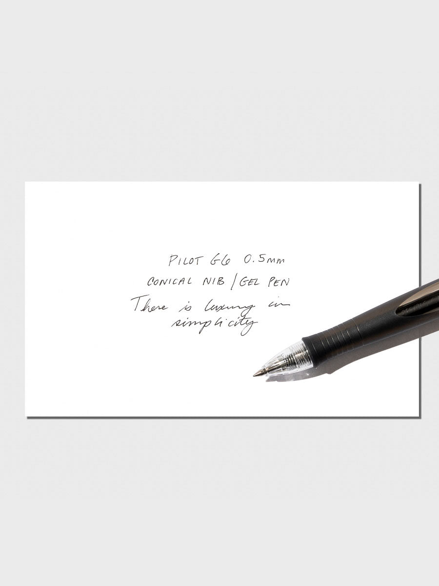Pen displayed with writing sample on a neutral background.