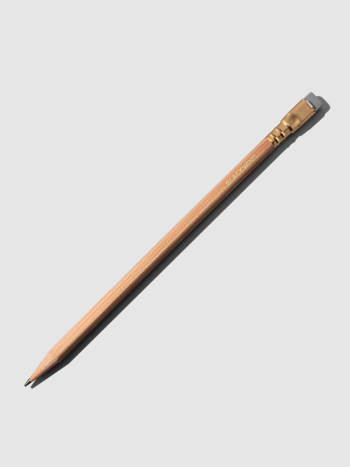 Brown wooden pencil displayed on a neutral background.