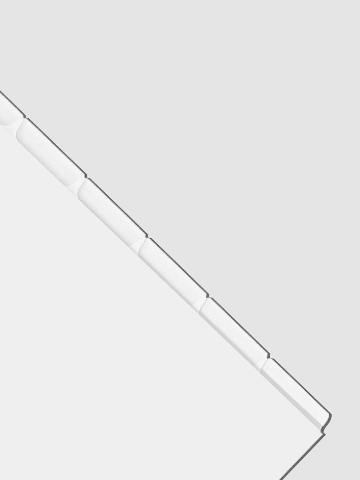 Closeup of blank divider tabs on a neutral background.