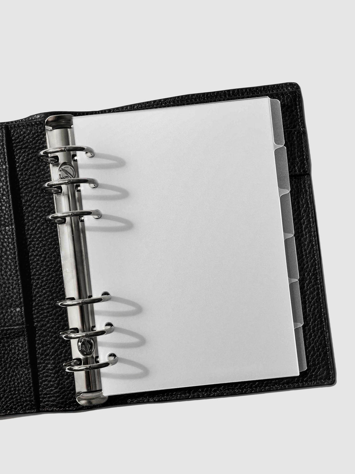Personal Wide Blank side tabs shown in use inside a black leather planner.
