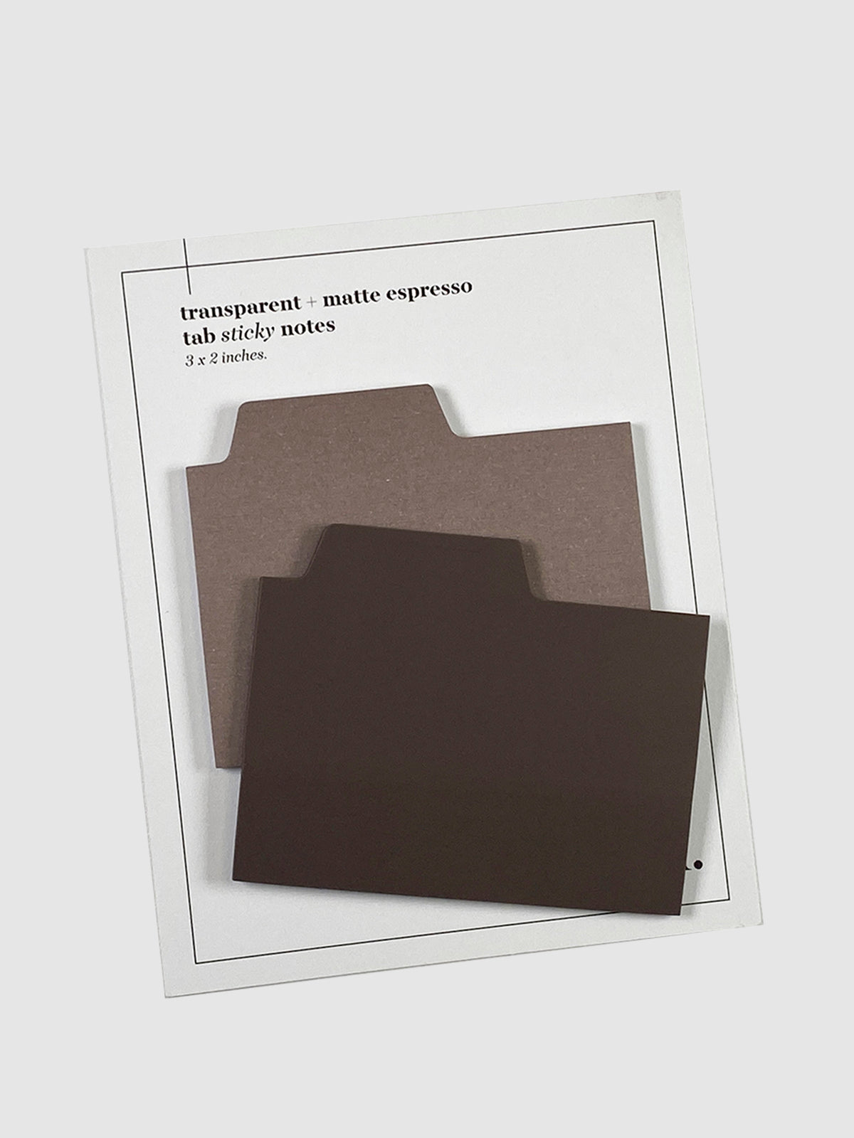 Blank Tab Sticky Note Set, Espresso, Cloth and Paper. Sticky note set displayed against a neutral background. The matte sticky note pad is attached to the sticky note backing, while the transparent sticky note pad is layered on top of it, turned slightly to the right.