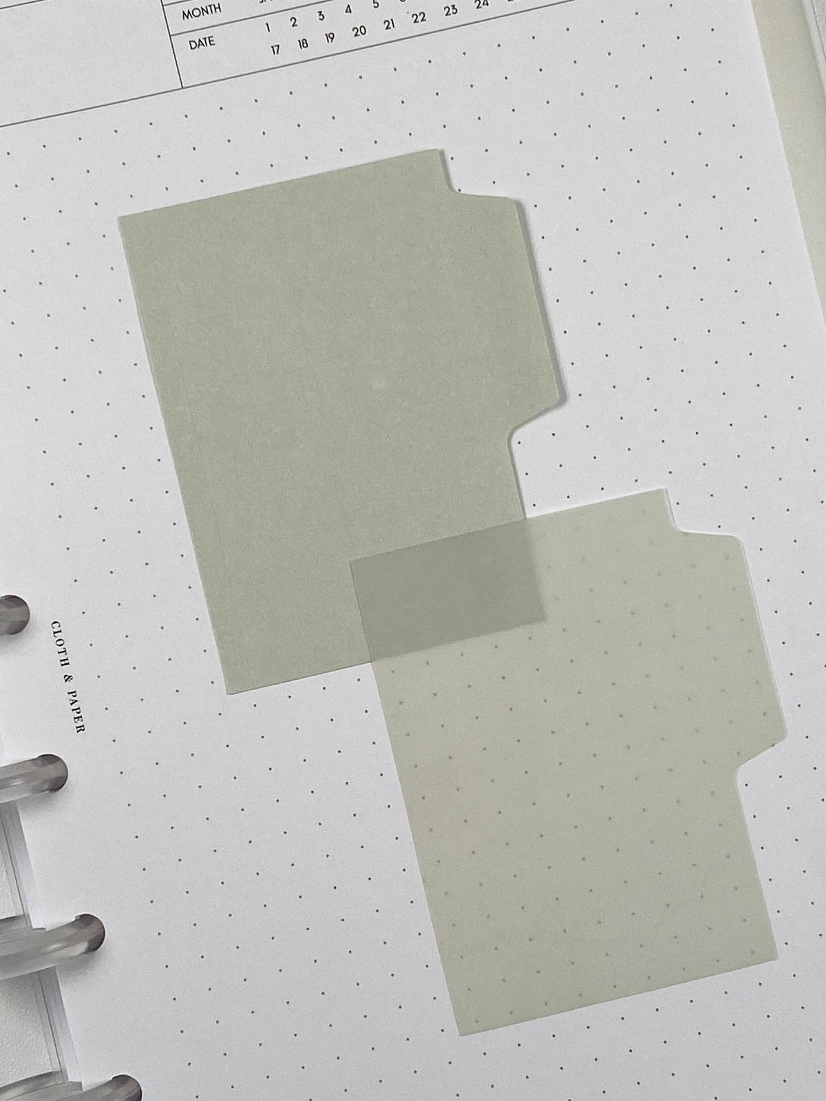 Blank Tab Sticky Note Set, Fawn, Cloth and Paper. One matte and one transparent sticky note from the set placed on a task insert. The transparent sticky note is layered over the bottom right corner of the matte sticky note.