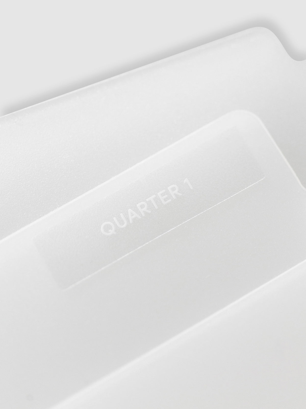 Close up of folder with label reading "Quarter 1." Text is white.