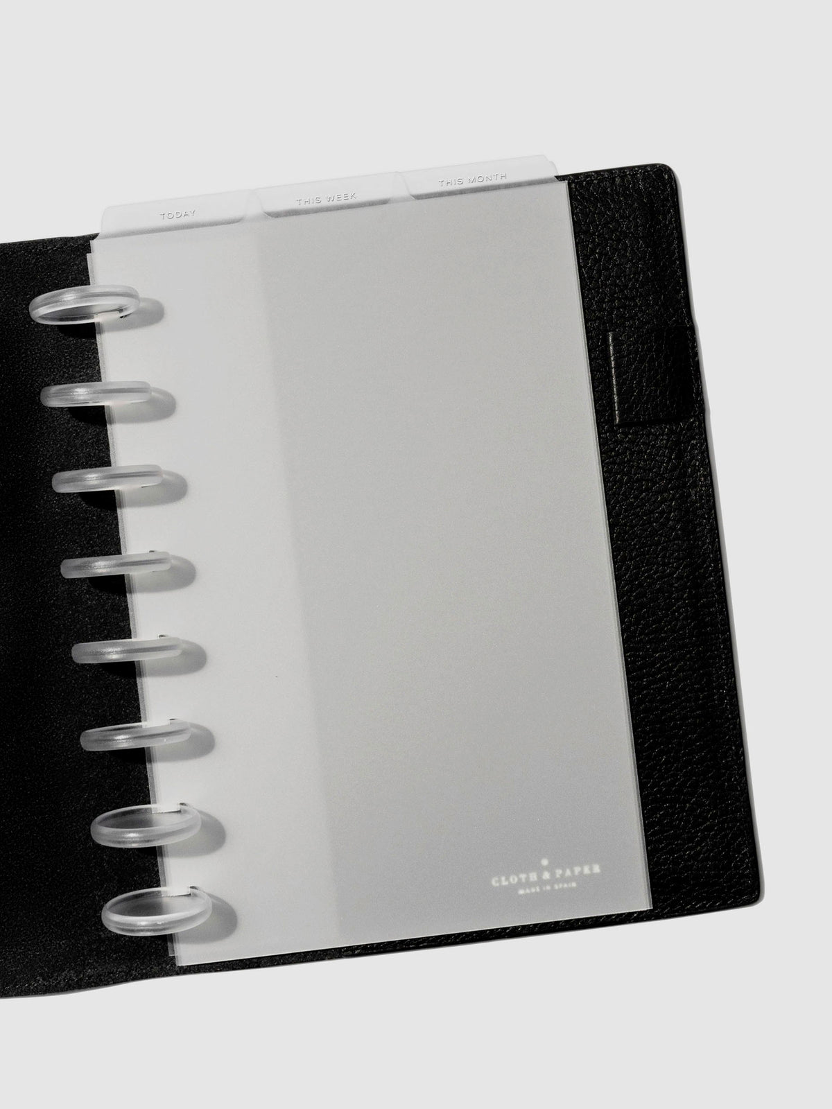 Half Letter White Foil Cadence Tab Dividers displayed in a black leather planner.