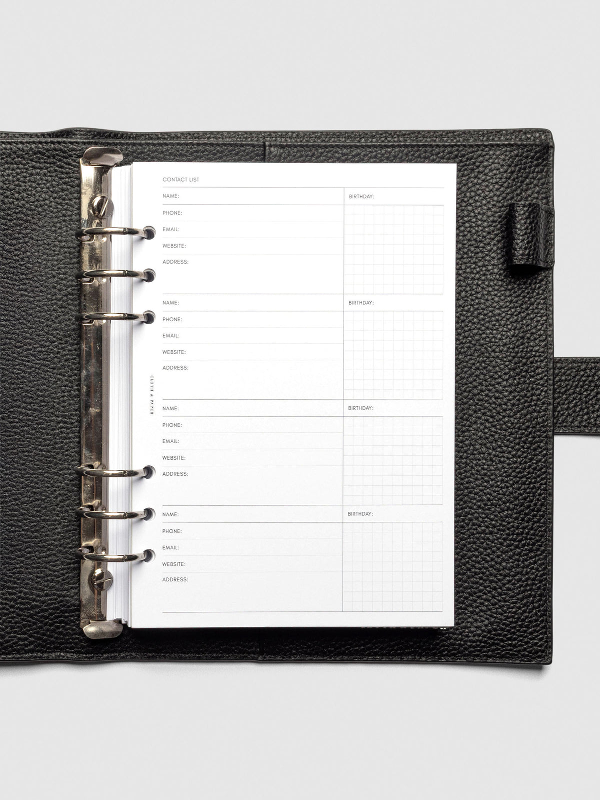 Refreshed Contact List Planner Inserts styled inside a black leather agenda.