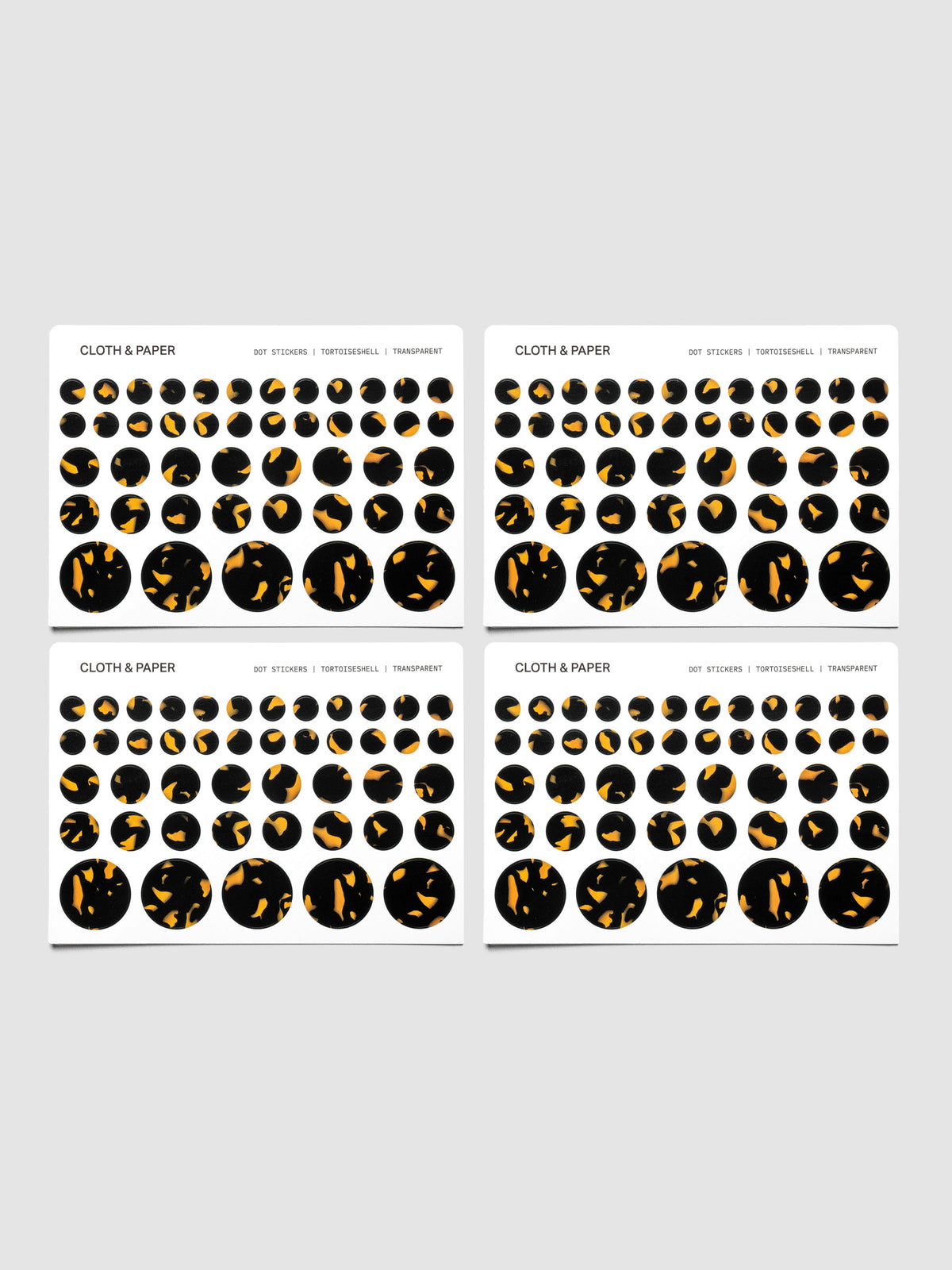 Tortoiseshell stickers displayed on a neutral background. Four sheets are placed next to each other showing small, medium, large, and mixed sticker sizes per sheet.