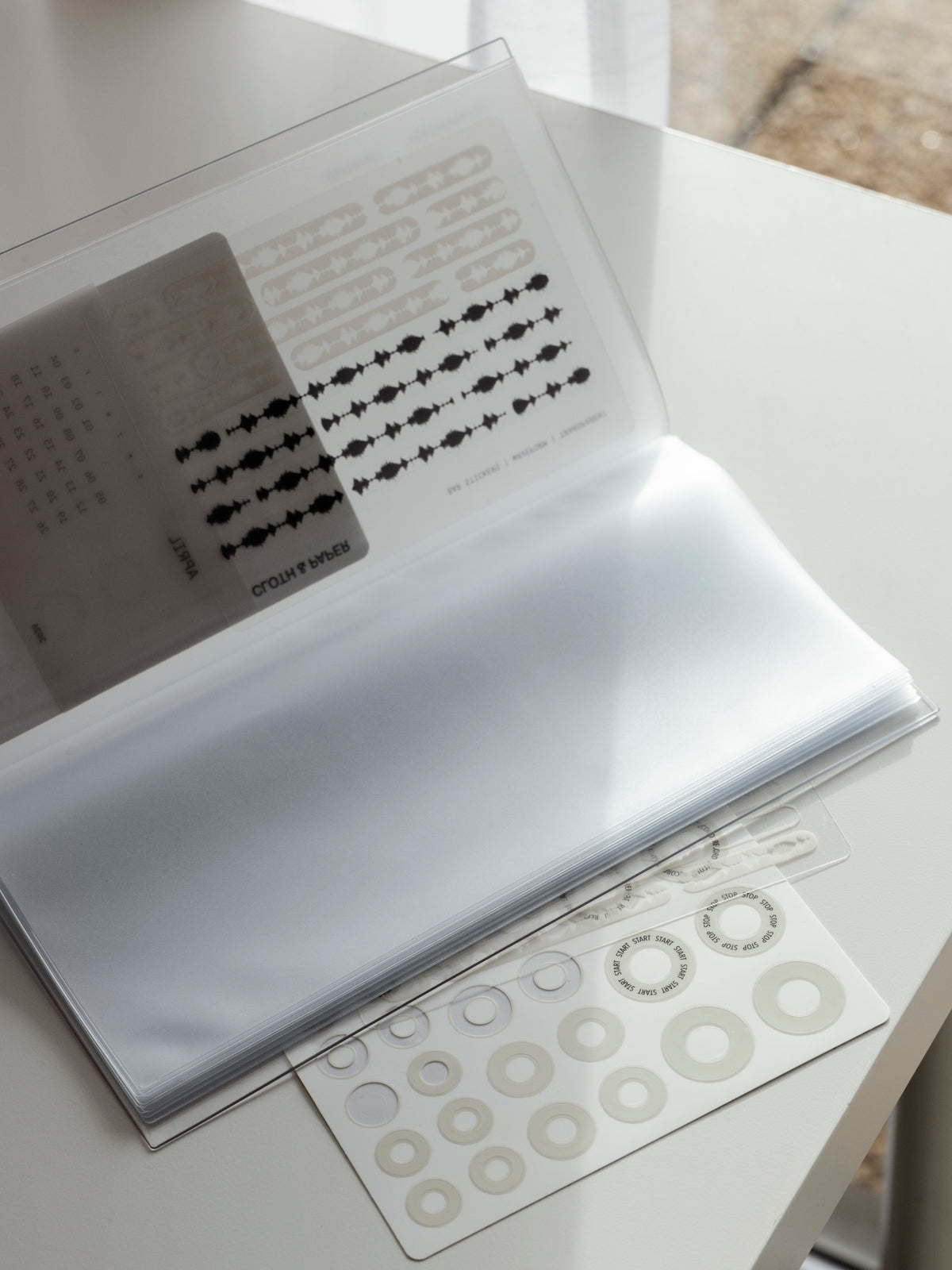 A5 Slim sized clear organizer with sticker sheets placed in a pocket.