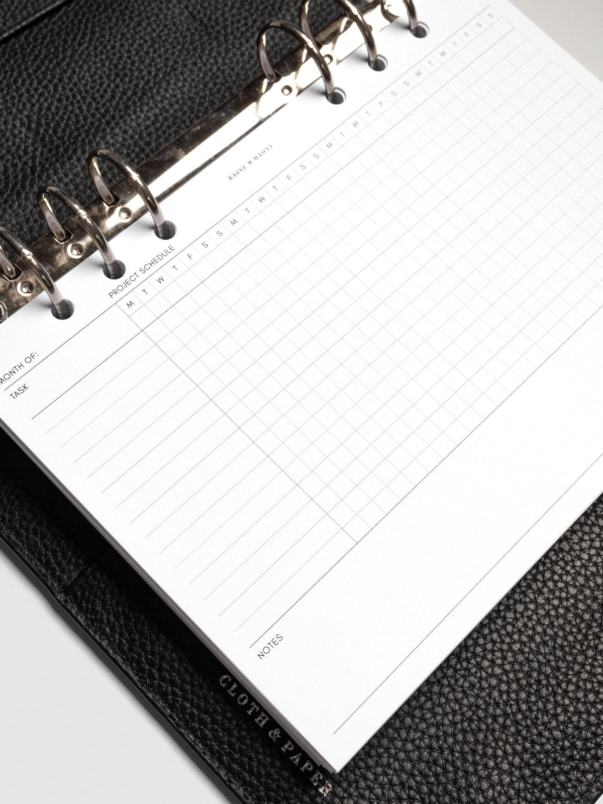 Close up of GanttChart inserts inside discbound planner and leather cover.
