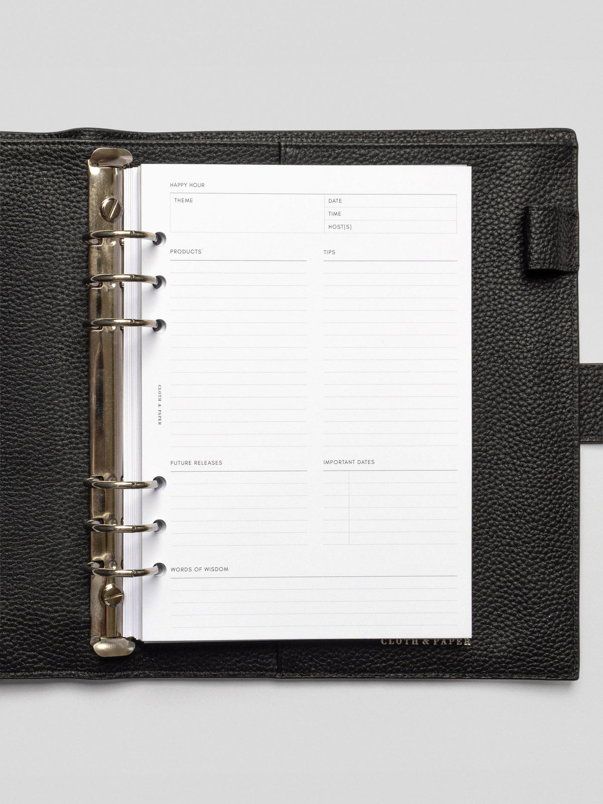 Open black leather planner featuring a blank Happy Hour Notes Insert with structured sections for theme, products, tips, and more.