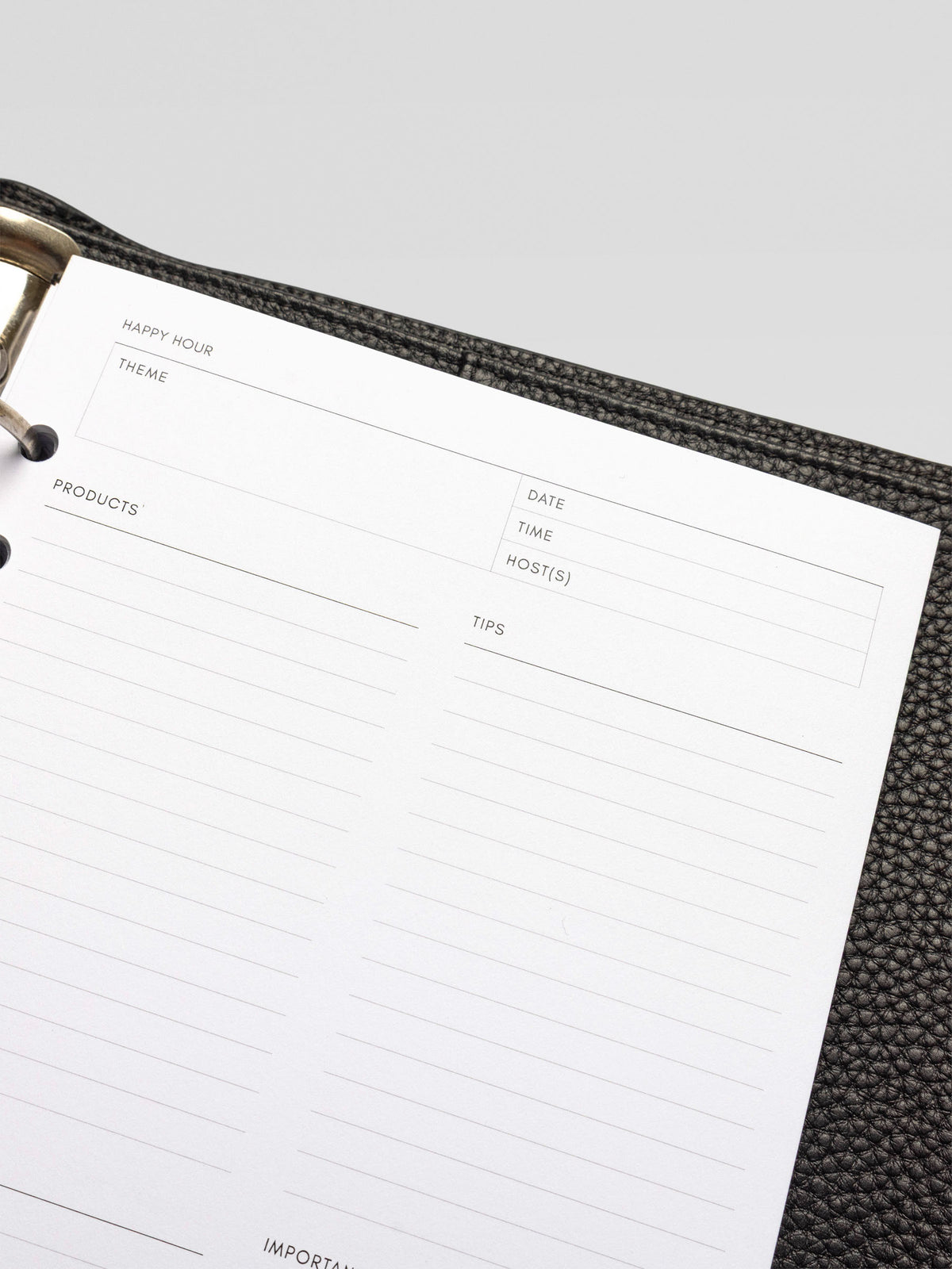 Close-up of the top half of a blank Happy Hour Notes Insert inside a black leather planner.