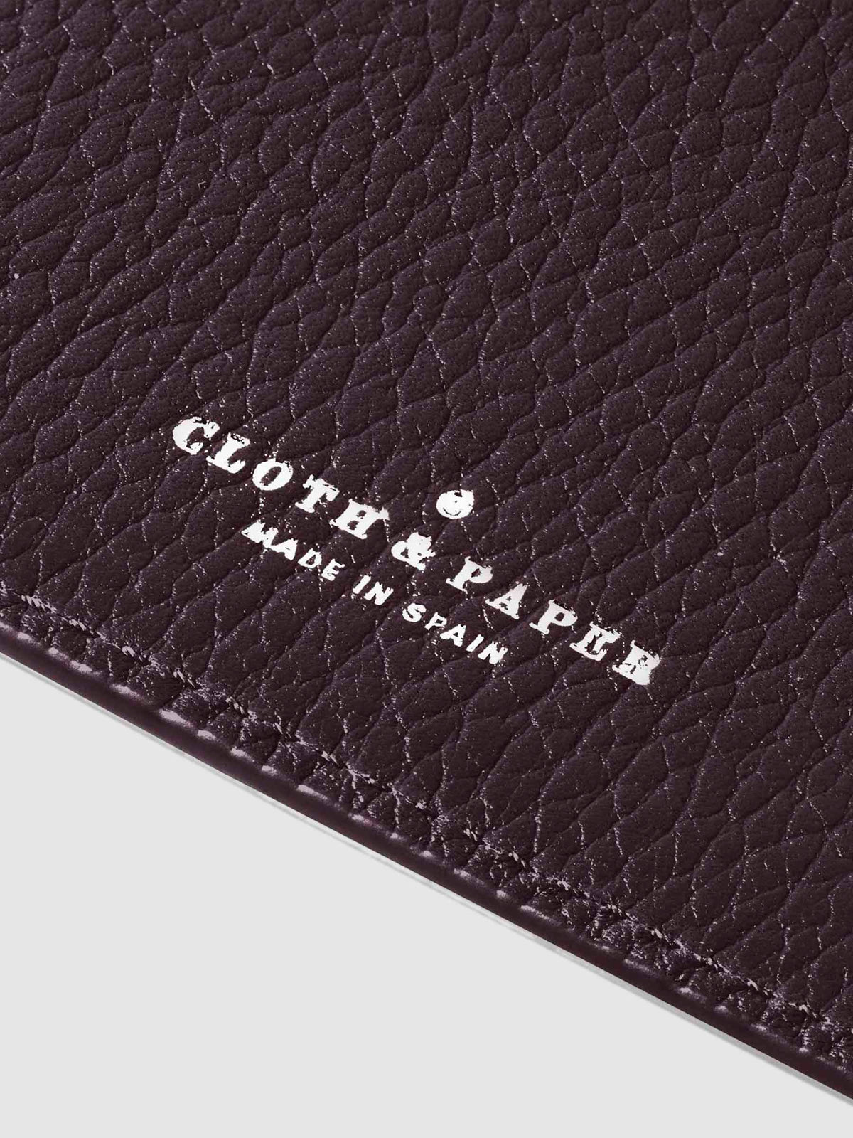 Closeup of silver stamping on leather folio.